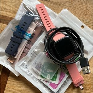Rose Gold FitBit Versa with extra bands